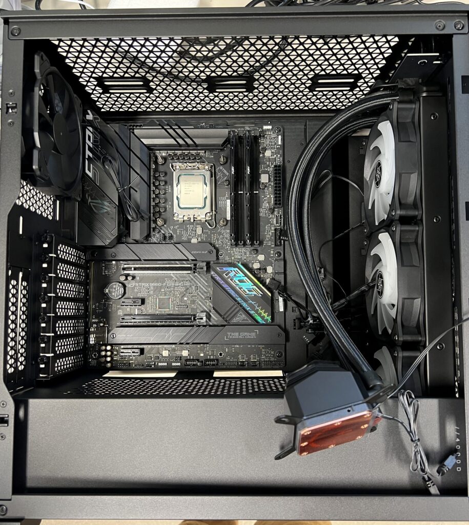Custom PC build in progress with ASUS ROG Strix motherboard, CPU and memory installed